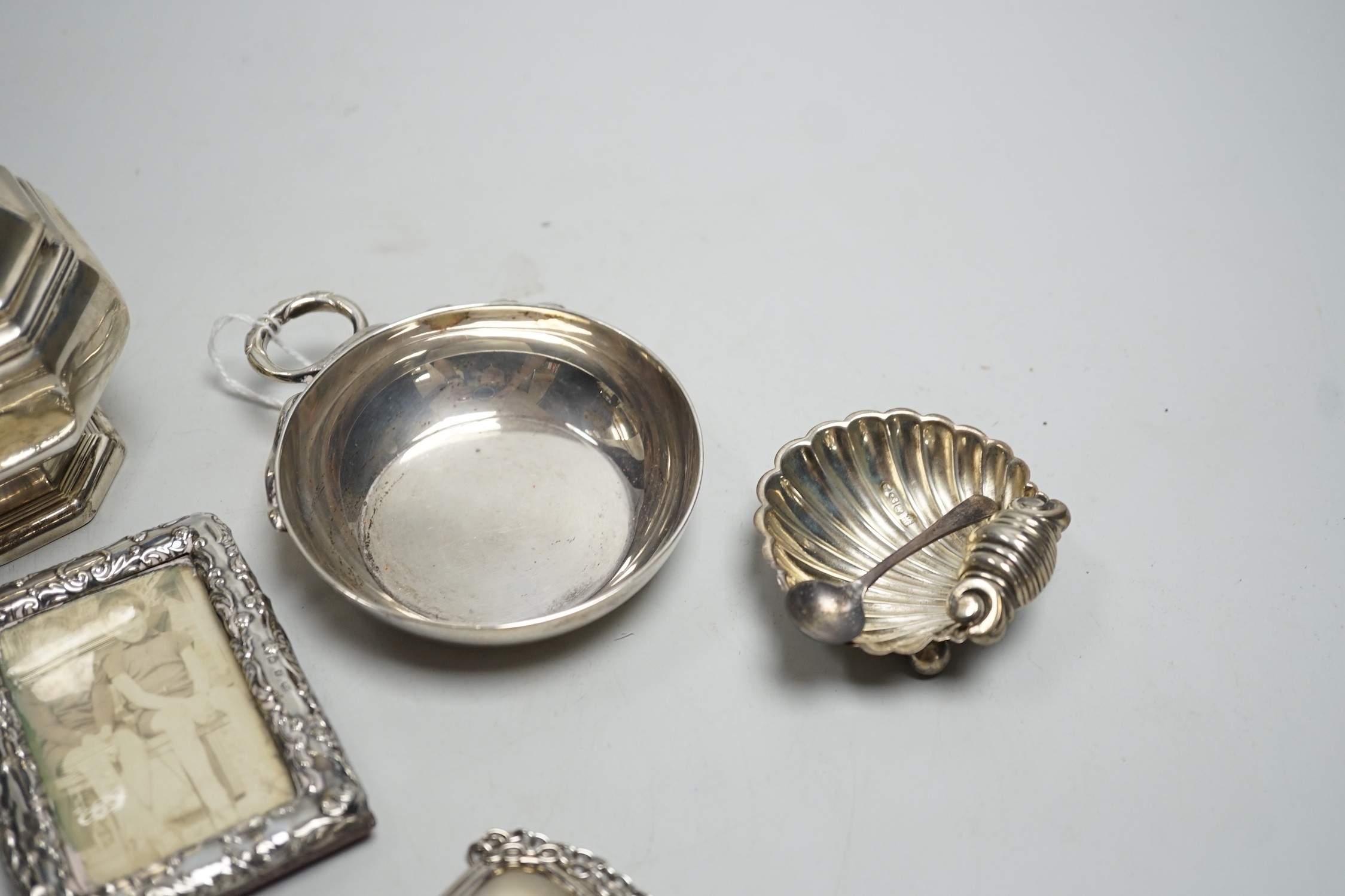 A George V silver octagonal baluster sugar caster, by Walker & Hall, 16.4cm, a modern silver taste du vin, three modern silver wine labels, a silver shell salt, silver condiment spoon and a late Victorian miniature silve